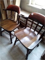Two wooden kitchen chairs with leather backs