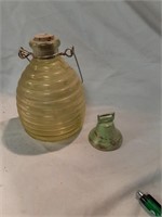 A glass bee trap and also a brass bell