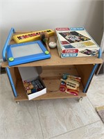 Vintage toy wheeled cart with various vintage toys