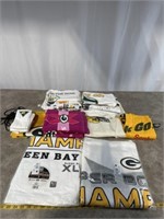 Large assortment of Packer towels, bags, and