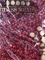 Miyuki 5 mm glass pony beads. Transparent red.