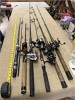 Six fishing poles with reels