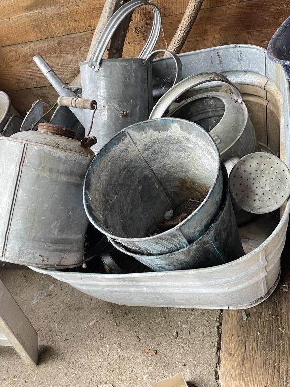 galvanized tub with planters and water cans