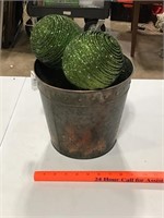 Metal bucket and green balls