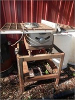 outside-Old Craftsman table saw on stand