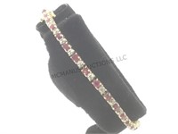 14k glold tennis bracelet w/red & clear gemstones