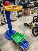 Plastic toy dump truck and basket ball hoop