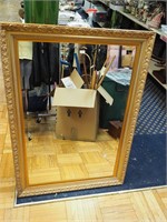 Beveled wall mirror in gold frame