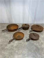 Set of cast iron pans, some have lids. Will need