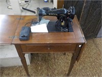 Early Singer sewing machine in stand J0226451