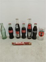 Coca-Cola bottle collection with wooden pencils