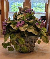 Basket with artificial flowers and cat