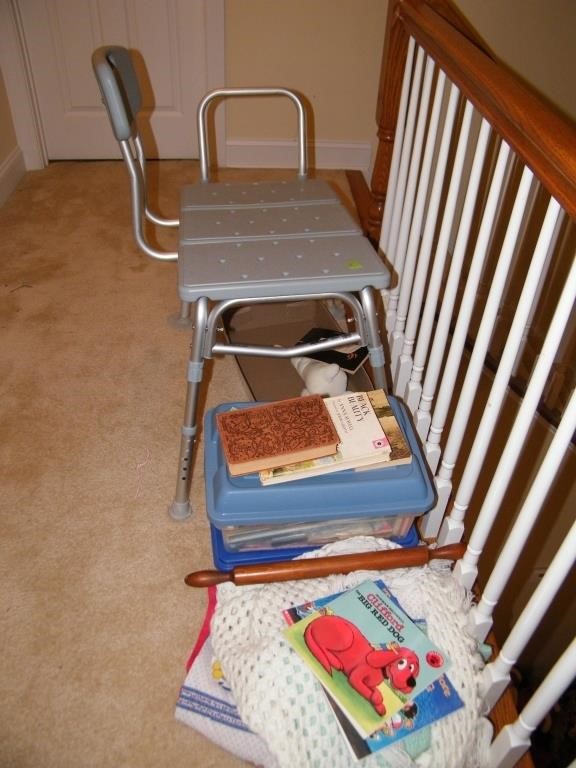 SHOWER CHAIR AND BOOKS IN HALL