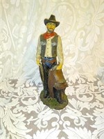 Cowboy holding a sattle