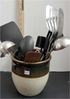 Crock with kitchen utensils.