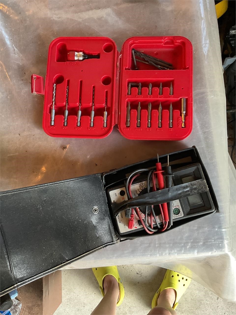 Battery tester and case of drill bits