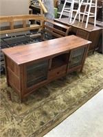 Nice modern tv stand with leaded glass front. 63