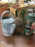 Coleman lantern and metal watering can
