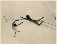 8X10 OF IN AIR TRAPEZE STUNT