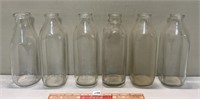 SIX VINTAGE MILK BOTTLES