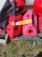 Two red five gallon gas cans used for diesel