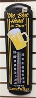 Vintage style tin thermometer, says "Lucky's Bar"