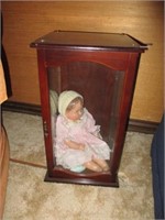 vintage doll in wood cabinet