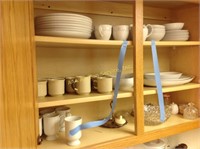 Contents of cabinet: set of dishes and cups chips