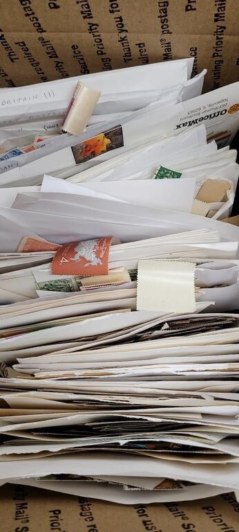 Worldwide Stamps many thousands off paper in envel