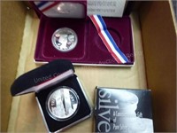 2 pieces: 1983 Olympic silver dollar & World Trade
