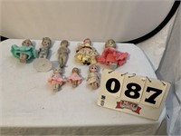 7 Vintage Porcelain dolls and one cloth doll.