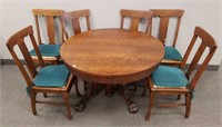 Antique round oak claw foot table with 6 t-back