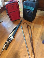 2 carry on bags, canes, umbrellas, spear