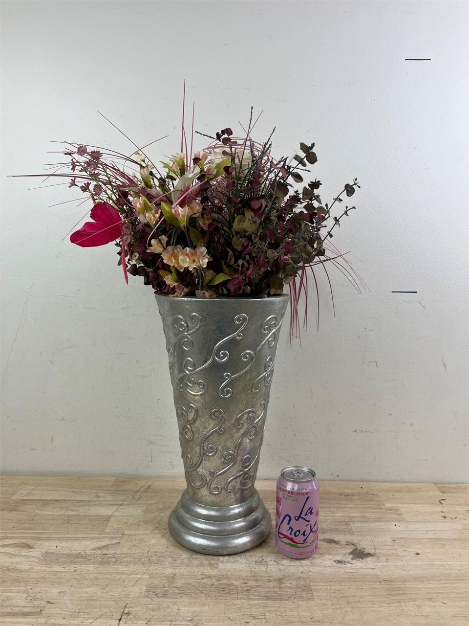 Large silver vase with artificial flowers