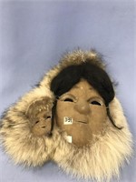 Caribou hide mask of woman and baby with wolf ruff