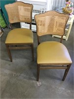 Two folding chairs with cane back