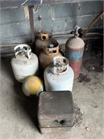 Four propane tanks, one miscellaneous tank, gas ta