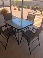 Patio table with four folding chairs #165