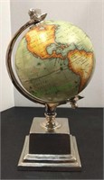 World globe on silver tone metal base and frame.