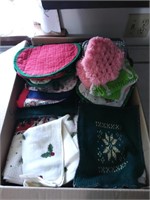 Box lot of pot holders, dish towels and more.