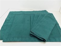 Four green placemats and napkins