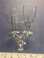 F1)Three very fine, delicate wine glasses. They’re