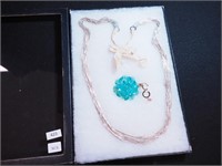 Multi-strand silvertone necklace; aqua crystal