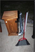 cabinet. stove pipe. broom. board with pegs