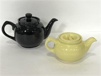 Pair of black & yellow ceramic teapots