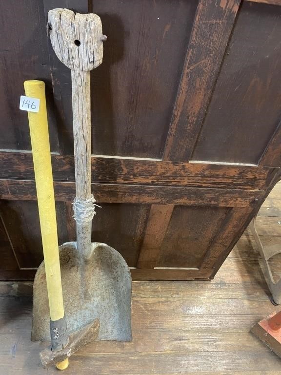An axe and old wooden handle shovel