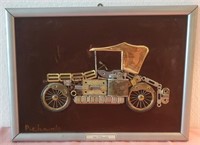 703 - FRAMED METAL ARTWORK 1926 OLDSMOBILE