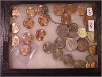 Container of coins: seven Sacajawea dollars; five