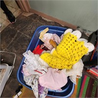 Bin of baby doll clothes