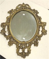 Ornate brass framed wall mirror